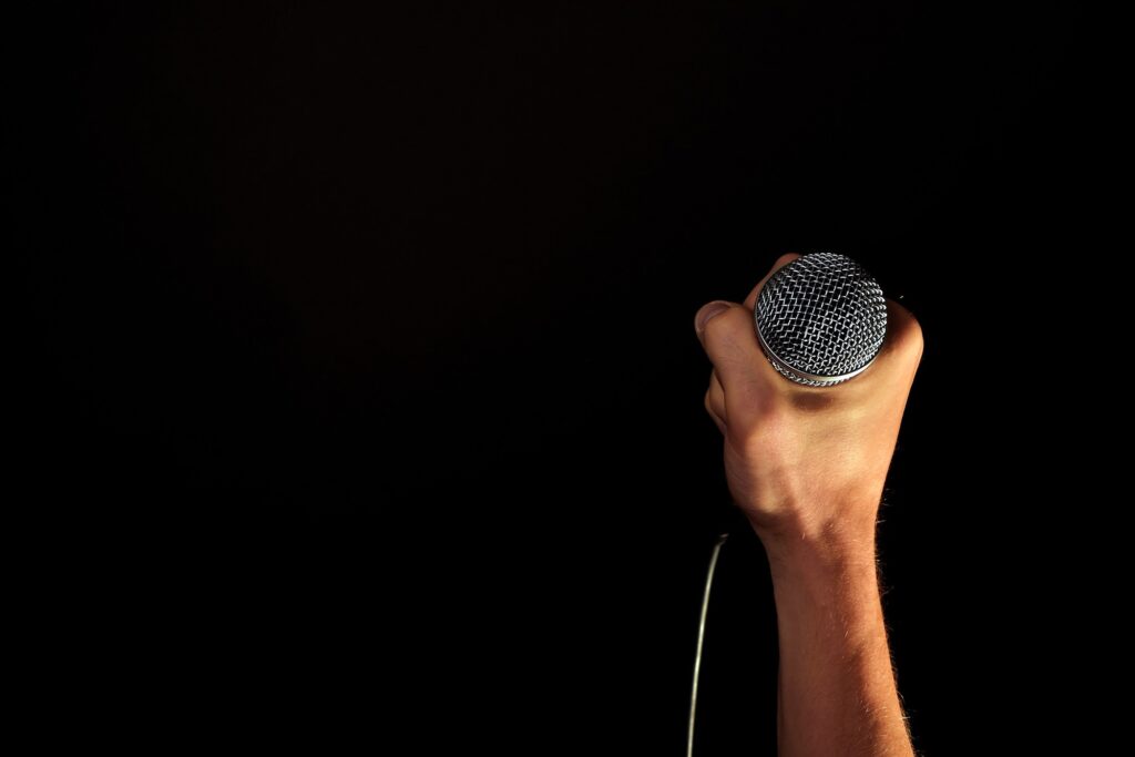 A hand gripping a microphone tightly